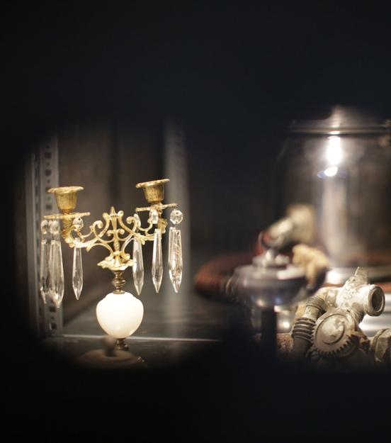 Ein Kerzenleuchter und Objekt mit Röhren und Gewinden sind Teil der Wunderkammer